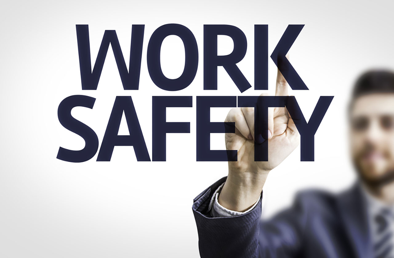 Work safety text with business man pointing behind