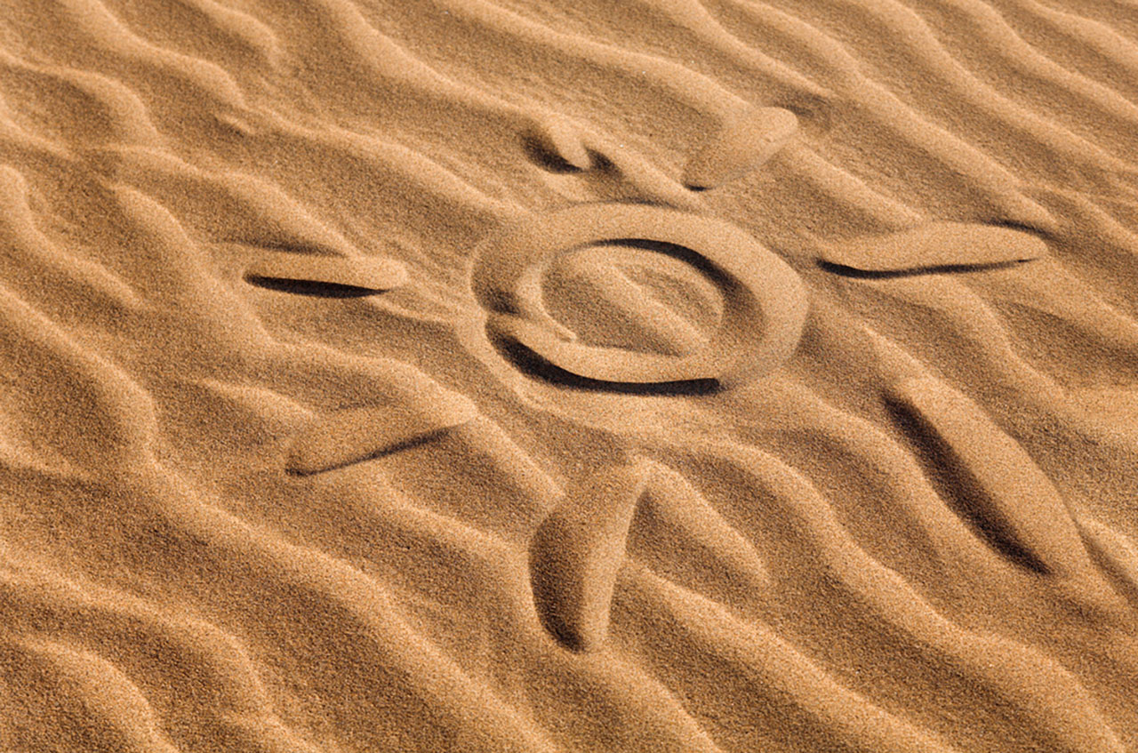 sun shape on sandy beach